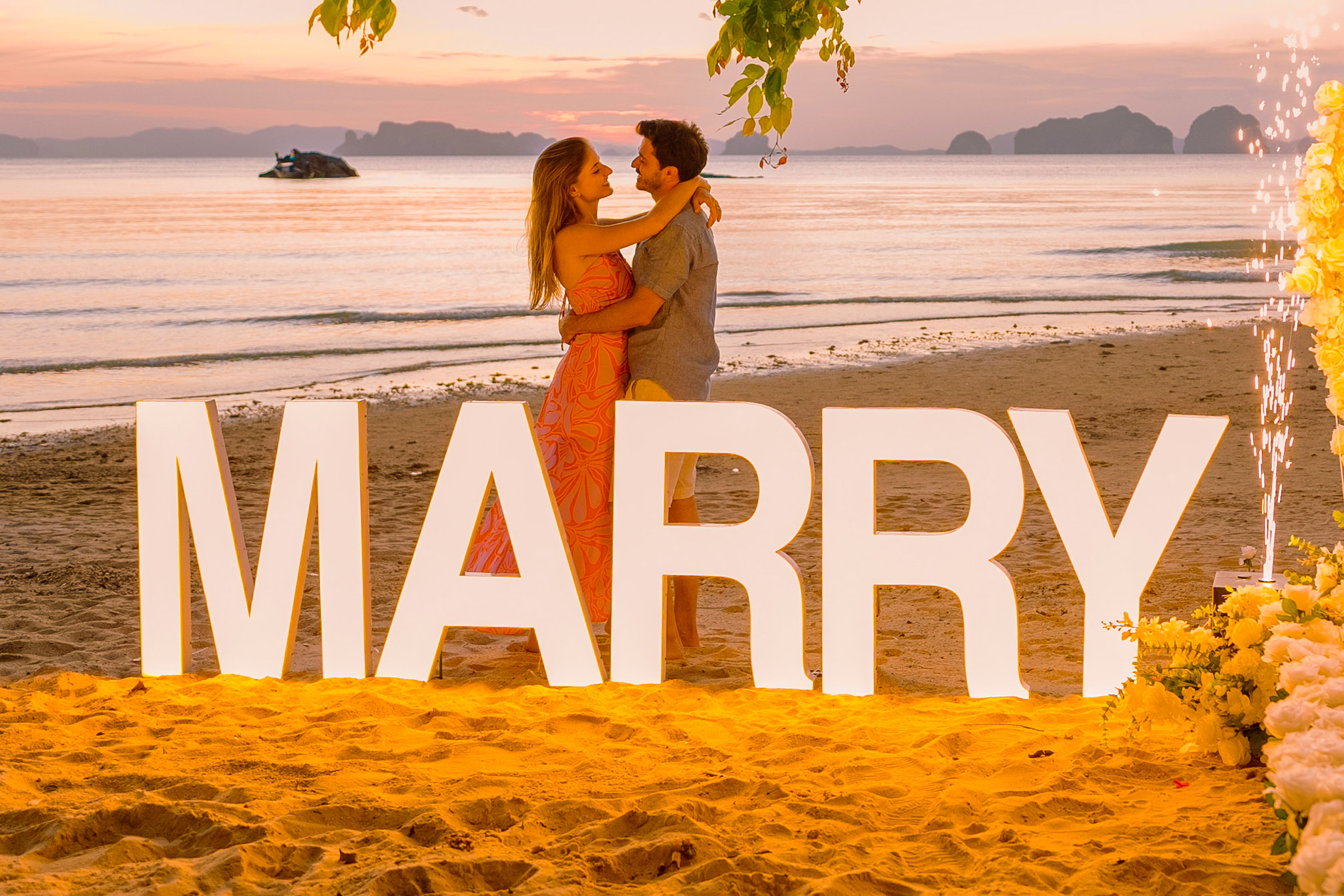 Large MARRY ME letters on the sand